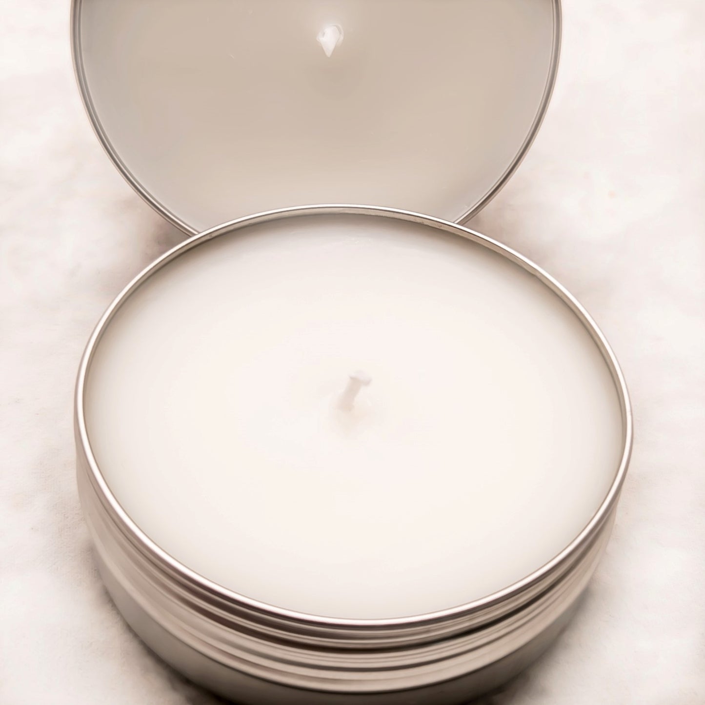 image of 2 oz travel or sample size candles with the lids off on a white background