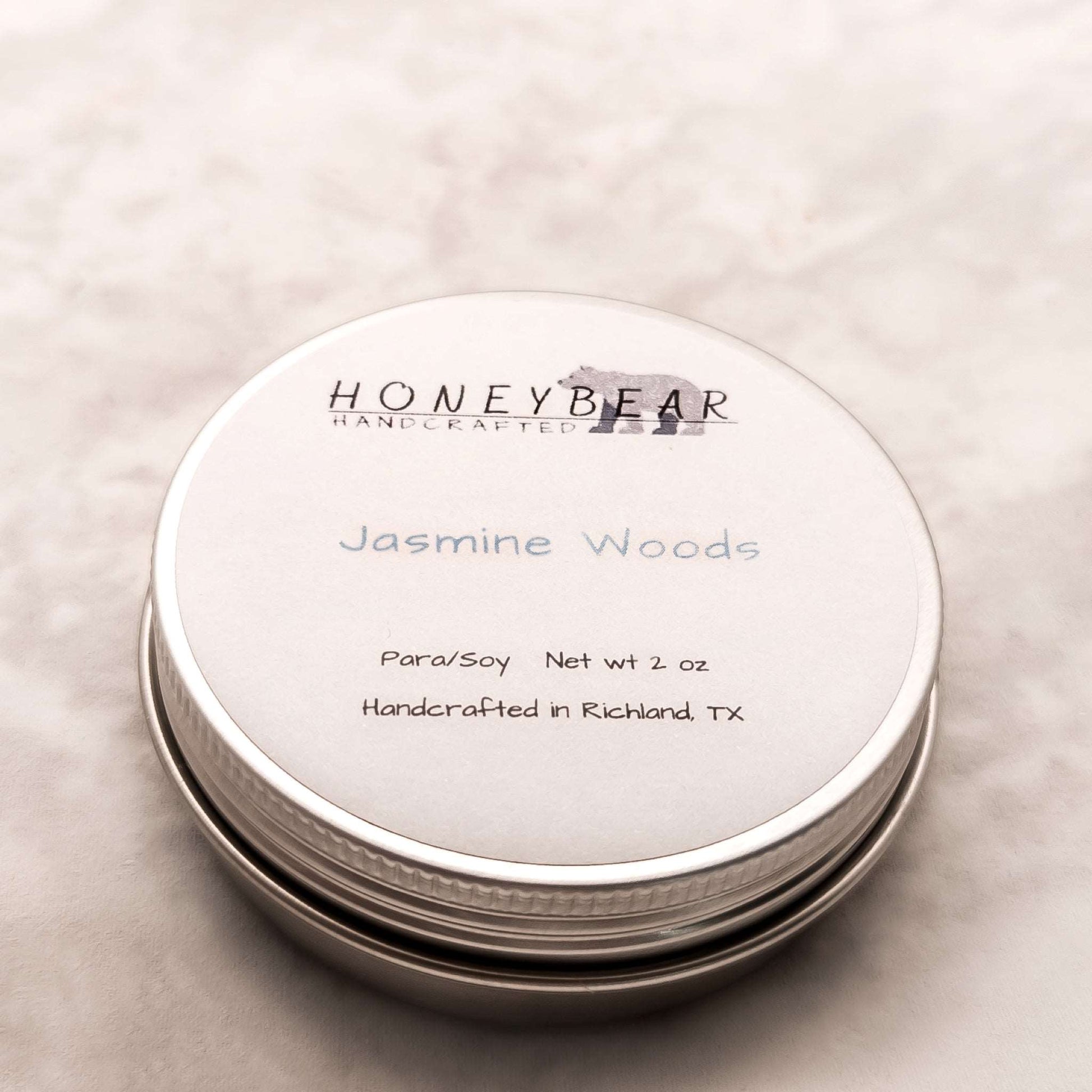 image of 2 oz travel or sample size candle labeled Jasmine Woods on a white background