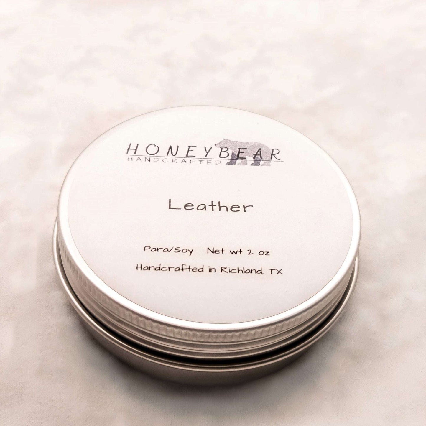 image of 2 oz travel or sample size candle labeled Leather on a white background