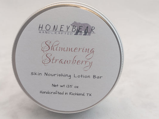 Shimmering Strawberry lotion bar in a silver tin on white background. Luxurious skin nourishing lotion bar.  Romantic scent.